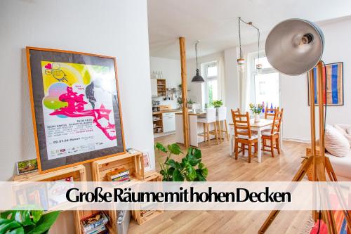 a living room with a television and a dining room at Helles Altbau-Loft mit Kingsize Bett, Smart-TV, etc in Erfurt