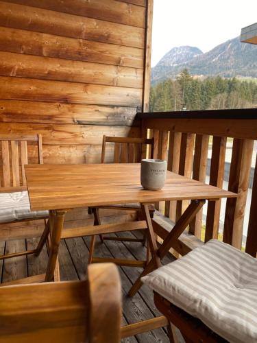 a wooden table and chairs on the porch of a cabin at Apartment Bergzauber in Reith im Alpbachtal