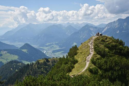 two people sitting on top of a mountain at Apartment Bergzauber in Reith im Alpbachtal