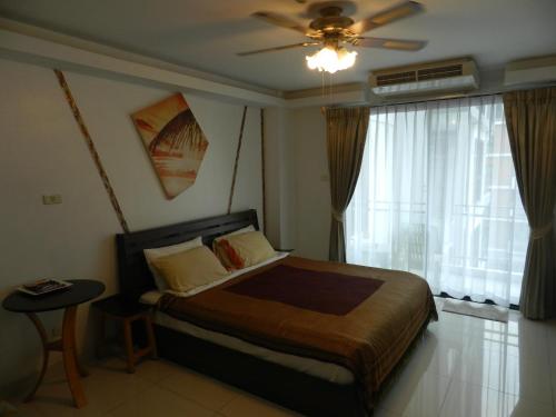 Ένα ή περισσότερα κρεβάτια σε δωμάτιο στο NEOcondo @ PATTAYA
