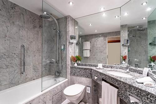 a bathroom with a toilet and a sink and a shower at Parkhotel Görlitz in Görlitz