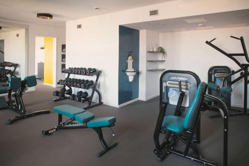 a gym with several exercise equipment in a room at Vienna House Easy by Wyndham Leipzig in Leipzig
