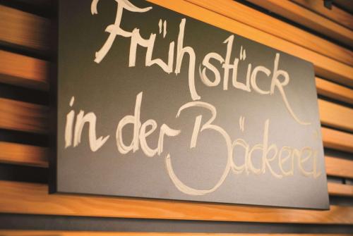 a sign on a wall that sayshitzitz inedergency at Vienna House Easy by Wyndham Landsberg in Landsberg am Lech