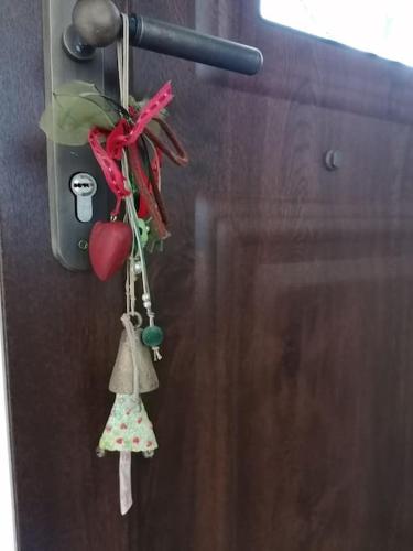 a pair of wind aids hanging on a door at Elli's view studio in Episkopíon