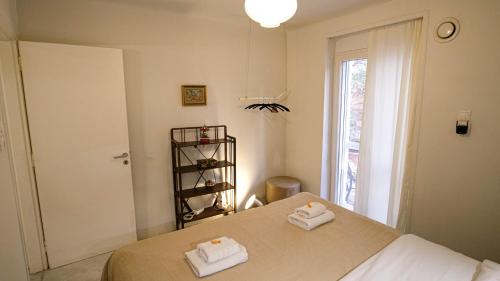 a bedroom with a bed with two towels on it at quiet and central FLAT with private backyard GARDEN in Athens