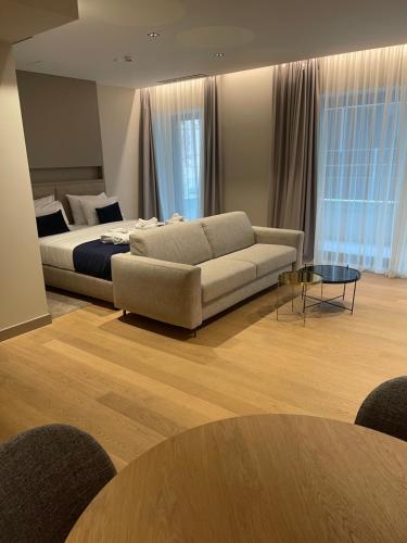 a living room with a couch and a bed at Boutique Hotel Porto in Dubrovnik