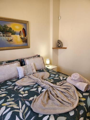 a bedroom with a bed with a blanket on it at Aloe Self Catering in Port Shepstone