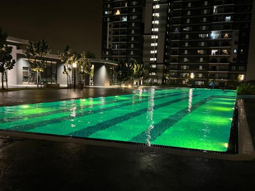 a swimming pool at night with green illumination at Homestay Cikgu Wanzarif@Bangi in Kampong Tangkas