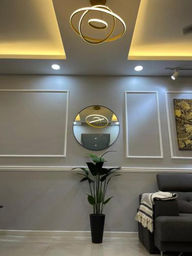 a room with a couch and a mirror on the wall at Homestay Cikgu Wanzarif@Bangi in Kampong Tangkas