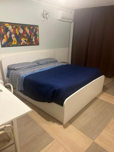 a bedroom with a bed with a blue blanket at Alla corte di Re Federico in Lamezia Terme