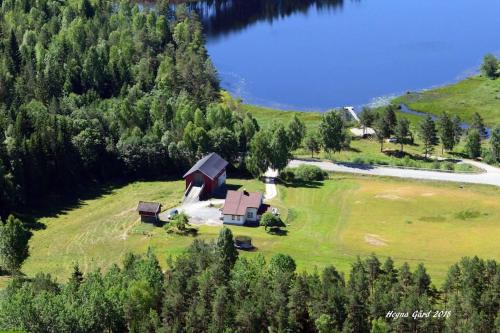 an aerial view of a house on a hill next to a lake at Unik overnatting i Stabbur/Minihus in Lunde