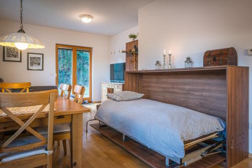 a bedroom with a bed and a wooden headboard at Apartments Plan Kranjska Gora in Kranjska Gora