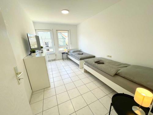 a room with two beds and a desk in it at Nice 2,5-Room Apartment in Untergruppenbach