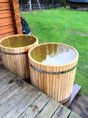 two large wooden buckets sitting on a deck at Sodyba Duburiai in Ukmergė