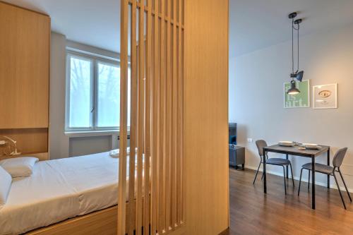a bedroom with a bed and a table in a room at V. Veneto Suite - Porta Venezia - Milano Centro in Milan