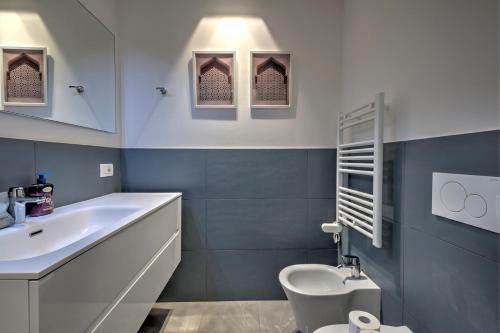 a bathroom with a white sink and a toilet at V. Veneto Suite - Porta Venezia - Milano Centro in Milan