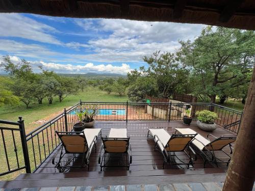 a deck with a table and chairs and a pool at 211 Zebula in Mabula