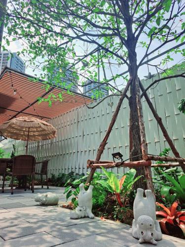 two white teddy bears are sitting on a patio at Nest by Sangob in Bangkok