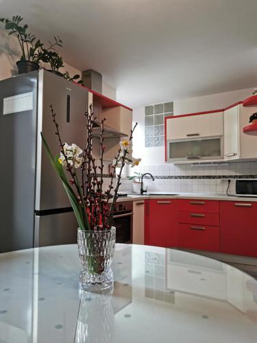 a vase with flowers on a table in a kitchen at Apartment Terassin in Koper