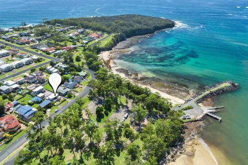 an aerial view of a beach with houses and the ocean at Crescent Harbour in Ulladulla