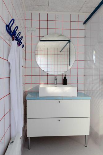 un baño con lavabo y espejo en Containerhus 18b, en Harboør