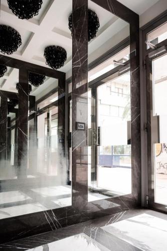 a lobby with a large mirror in the middle of a building at Salotto Room Boutique Pescara in Pescara