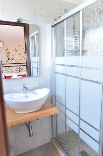 a bathroom with a sink and a glass shower at Villa Anté in Angri