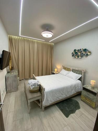 a bedroom with a bed and a television in it at Estancia Nápoles, CANA BAY Hard Rock. in Punta Cana