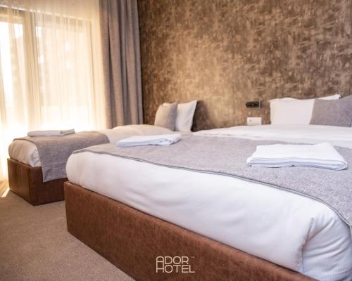 A bed or beds in a room at Ador Hotel North Mitrovica