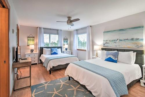 a hotel room with two beds and a television at Canal-Front Vacation Rental in Ocean Shores in Ocean Shores