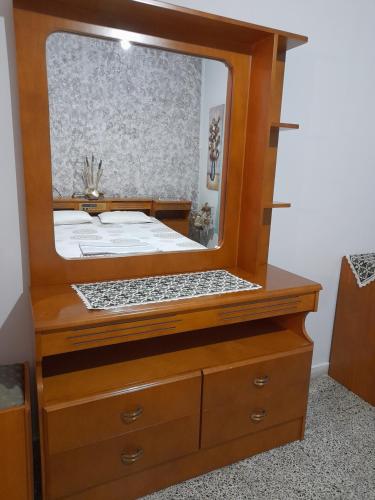 a bedroom with a large mirror on a dresser at Antonioy Apartment in Diáva