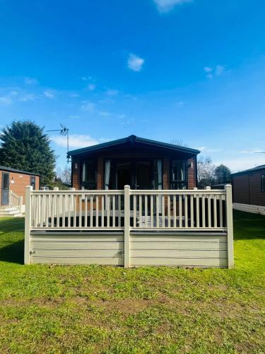 a white fence in front of a house at Dakota Lodge with Hot Tub in York