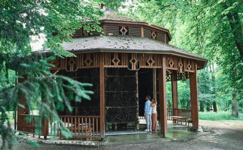 a couple standing in a pavilion in a park at EurothermenResort Bad Hall - Hotel Miraverde in Bad Hall