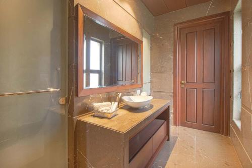 a bathroom with a sink and a bowl on a counter at Stay Vista at Ekant Villa - 3BR in Amritsar