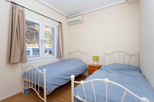 a bedroom with a bed and a window at CH Villa Golf Park La Marquesa in Rojales