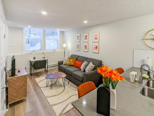 a living room with a couch and a table at GlobalStay Cranbrook Townhome Suites in Calgary