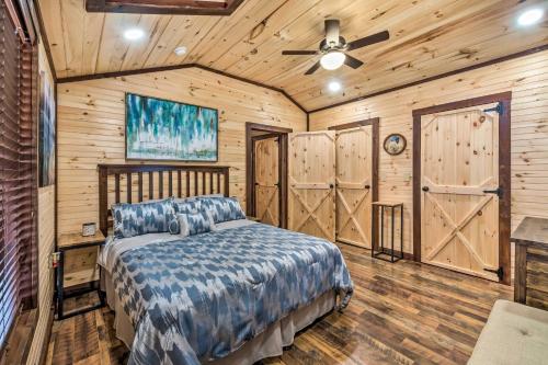 a bedroom with a bed and wooden walls at Somerset Cabin, Close to Lake Access! in Somerset