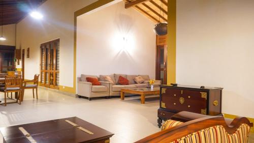 a living room with a couch and a table at Misty Hills Villa Kadugannawa in Kadugannawa