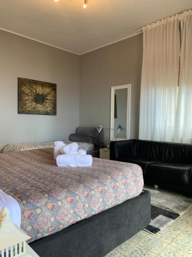 a hotel room with a bed and a couch at Maison belle Vue in Taormina