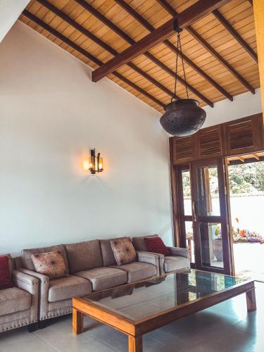 a living room with a couch and a coffee table at Misty Hills Villa Kadugannawa in Kadugannawa
