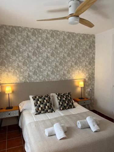 a bedroom with a large bed with two pillows at PUERTO BANUS POL One in Marbella