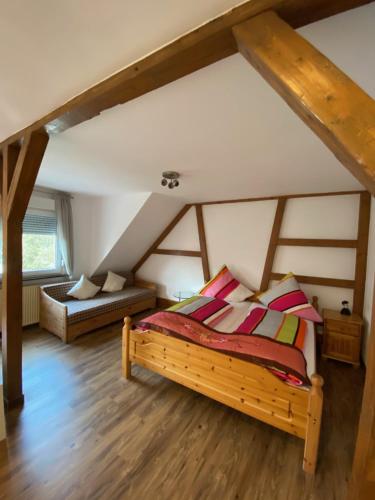 a bedroom with a wooden bed in a attic at Vintage Apartment in Adenau