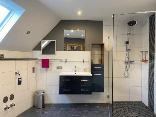 a bathroom with a sink and a shower at Vintage Apartment in Adenau