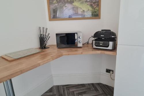 Large 4 bed (sleeps 8) Castle View في إدنبرة: كونتر عليه ميكروويف وفرن توستر