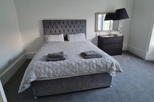 Large 4 bed (sleeps 8) Castle View في إدنبرة: غرفة نوم بها سرير كبير ومرآة