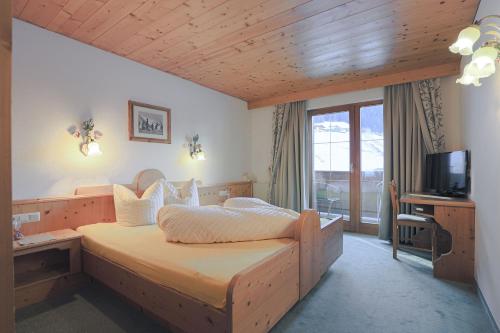 a bedroom with a bed and a television in it at Ausserwieserhof in Neustift im Stubaital