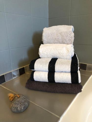 una pila de toallas sentadas en un mostrador en un baño en La Mulonniere en Saint-Sébastien-sur-Loire