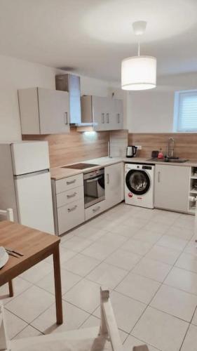 a kitchen with white appliances and a table in it at Wohnung in Dörverden in Dörverden