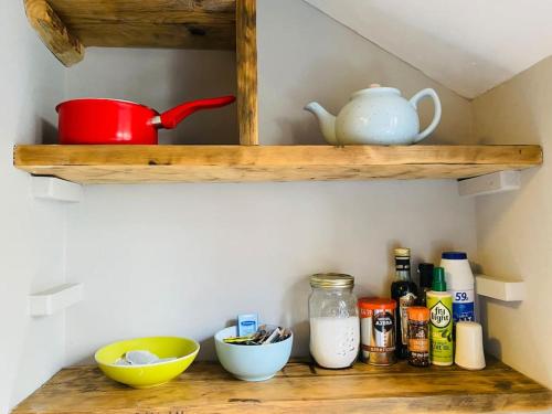 a wooden shelf with food items on it at Old Fisherman Nest in Old Town in Hastings