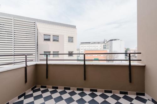 a balcony with a view of a city at Pavia Tower - by Host4U in Pavia